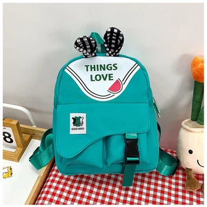Detail of green kids backpack with rabbit ears, plaid patterns and cute graphics