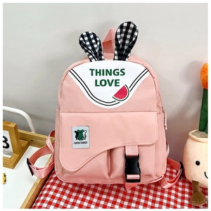 Detailed view of pink children backpack with rabbit ears and cute watermelon prints
