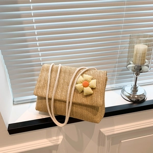 Handwoven straw tote bag with fabric flower and white cotton rope handles