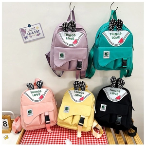 Detailed view of children's backpacks in five vibrant colors with cute rabbit ear decor