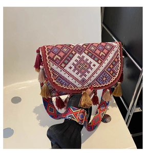 Close-up of bohemian jacquard weaving detail and colorful tassels on crossbody bag
