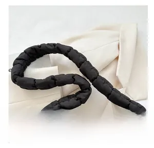 Detail showing the wide puffy pleated shoulder strap on this black quilted cloud bag