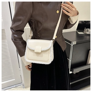 Detail showing creamy white PU leather crossbody bag with cozy faux fur trim texture
