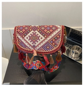 Detail of bohemian embroidery and long tassels on the ethnic crossbody bag with strap