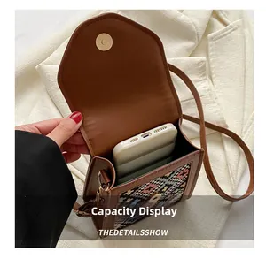 Vertical phone bag capacity display showing a smartphone inside a brown ethnic style crossbody