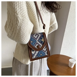 Vertical crossbody bag with ethnic woven pattern and brown leather trim detail