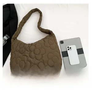 Brown quilted tote bag shown with a tablet and phone to demonstrate the large capacity size