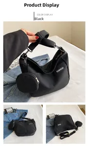 Detail of black large canvas tote bag with adjustable wide strap and small round coin purse