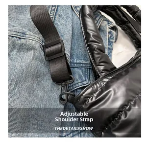 Detail of adjustable nylon shoulder strap and buckle on black quilted crossbody bag