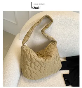 Detail view of khaki quilted puffer tote bag with large 3D floral stitch patterns