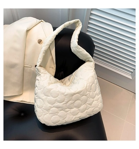 Detailed close-up of white floral quilted cloud tote bag with soft puffer nylon texture