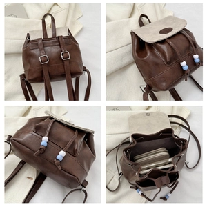 Detail view of brown and white backpack showing interior storage and adjustment buckles