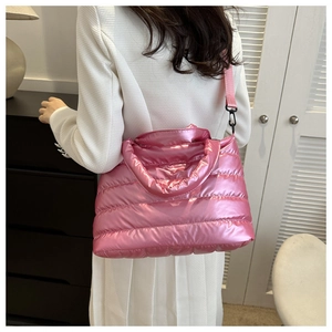 Detail view of pink quilted puffer tote bag with glossy metallic finish and shoulder strap