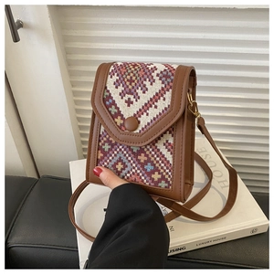 Detail showing vintage ethnic patterned weave and brown leather trim on crossbody phone bag
