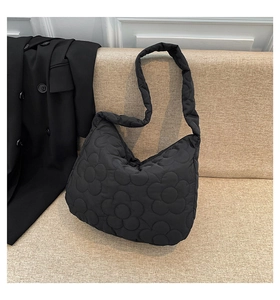 Detail shot of the black quilted floral puffer tote bag with comfortable wide shoulder strap