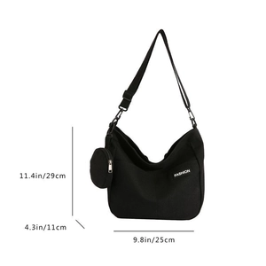 Detail showing dimension measurements and fashion label on black canvas tote bag