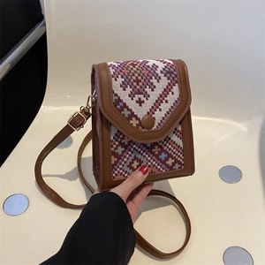 Vintage bohemian crossbody bag with ethnic woven pattern and brown leather trim