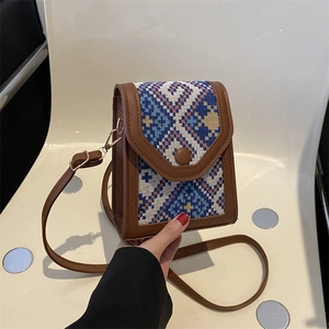 Vintage ethnic style woven phone crossbody bag with brown leather trim and shoulder strap