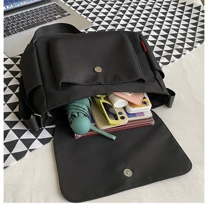 Grande borsa messenger in tela nera con spazio per tablet e oggetti di uso quotidiano