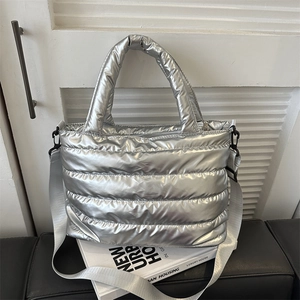 Silver quilted padded puffer tote bag with adjustable strap and metallic nylon finish