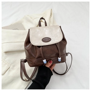 Detail of retro mini backpack in brown and cream PU leather with drawstring closure