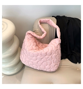 Close-up detail of pink quilted tote bag with floral stitching on soft nylon fabric