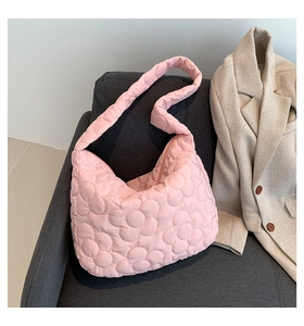 Close-up of pink quilted tote bag with floral pattern and soft cloud texture details