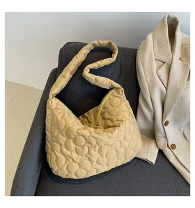 Detailed view of beige floral quilted texture on the soft nylon hobo shoulder bag