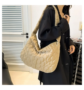 Lifestyle shot of light khaki quilted tote bag showing cloud texture and large capacity