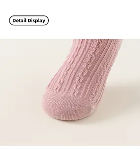 Detailed close-up of pink cable knit fabric texture on girls cotton knee high socks