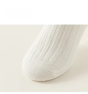 Detailed macro view of white ribbed knit fabric on cotton children socks toe area