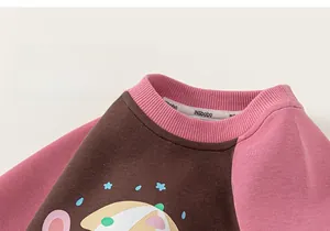 Detail of pink and brown raglan sleeves sweatshirt with soft knit texture and cartoon print