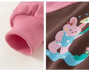 Detail shot of the ribbed cuffs and cute bunny cartoon print on a pink toddler sweatshirt