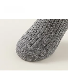 Detailed close-up of silver-gray girl's socks with sparkling lurex thread and ribbed texture