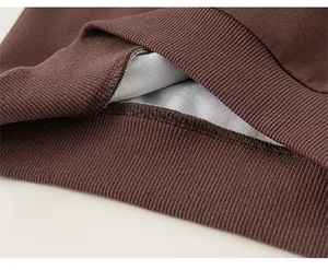 Close-up of ribbed hem on brown children sweatshirt showing durable stitching details