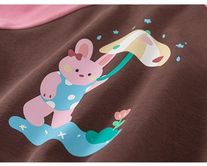 Detailed view of a cute pink bunny print on a brown and pink toddler cotton sweatshirt