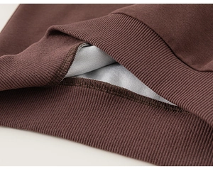 Detail of premium ribbed cuffs and soft grey fleece lining on kids' brown sweatshirt