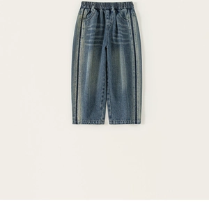 Macro detail of blue denim kids jeans showing elastic waist and side stripe accents