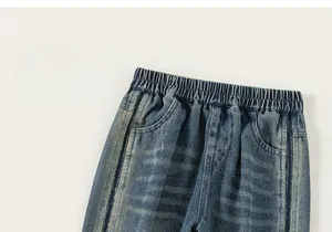 Detail of boys denim trousers showing elastic waistband and vintage blue wash fabric
