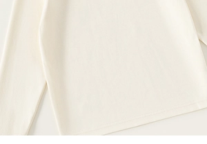 Detailed close-up showing the fine double-stitch sewing and soft texture of the cream top