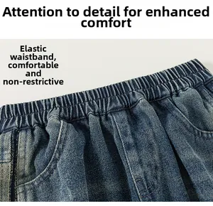 Detail of blue boys' denim jeans featuring an elastic waistband and premium stitching