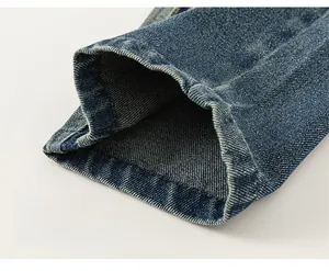 Close-up of durable double-stitched seams and premium blue twill denim fabric texture