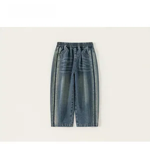 Close-up of boys' denim straight-leg jeans with elastic waistband and side stripe detail