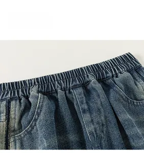Detailed macro view of the elastic waistband and heavy washed denim fabric texture