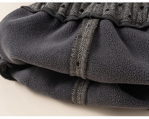 Macro view showing warm fleece lining and heart pattern fabric on girls winter trousers