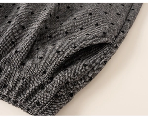 Detailed macro view of the grey heart-patterned fabric and elastic waistband with side pockets