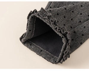 Macro shot of polka dot cuffs with ruffle edges and warm black fleece lining detail