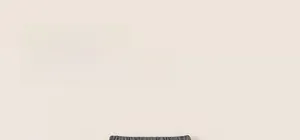 Close-up of elastic waistband on grey children's pants with black polka dots