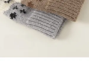 Close-up of thick knit wool texture on kid's cardigan sweater with ribbed cuffs