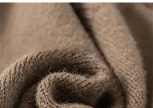 Detailed macro view of soft brown knit fabric showing the warm texture of kids cardigan